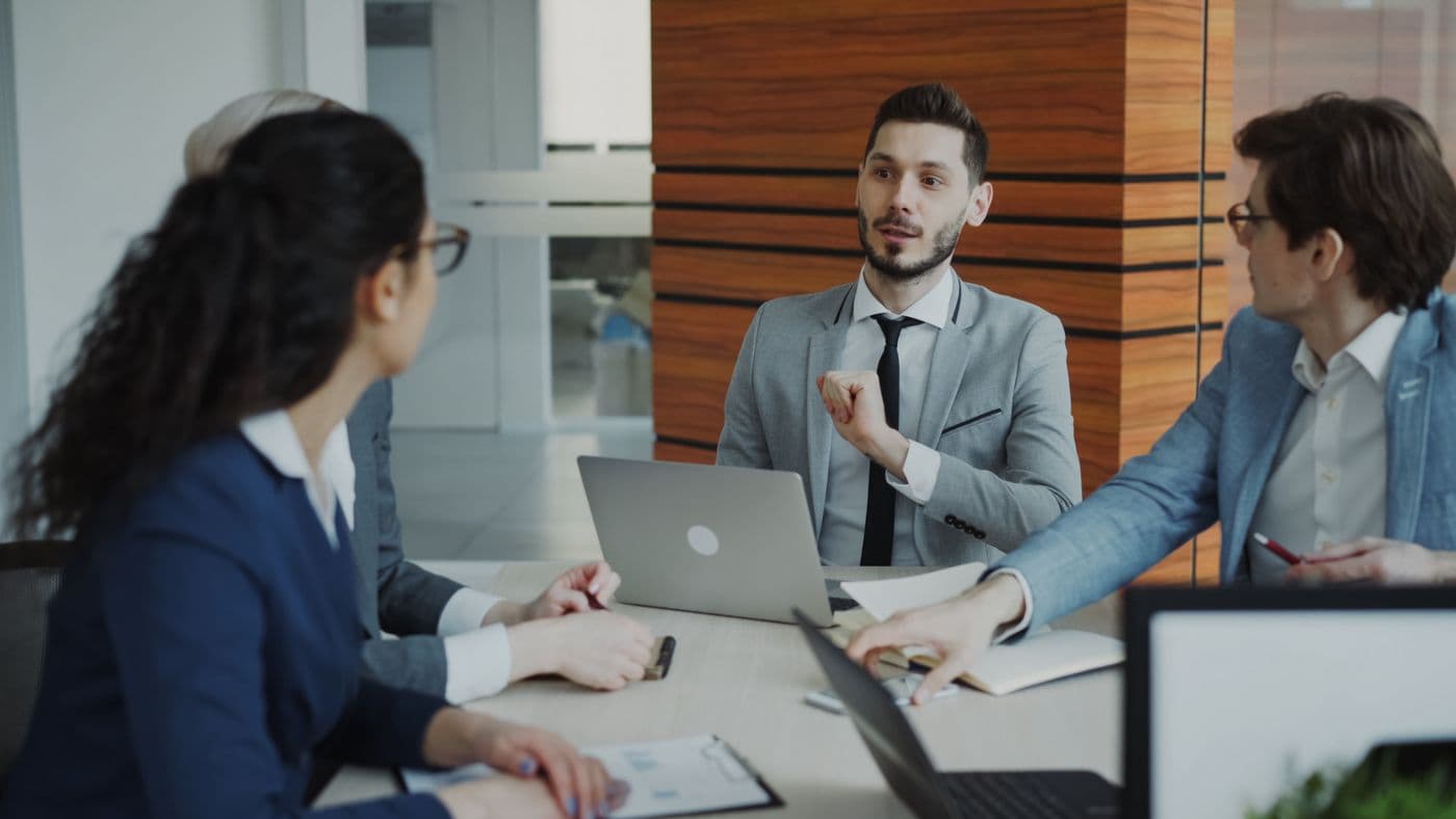 A Nexus Capitals Group team meeting in a modern office